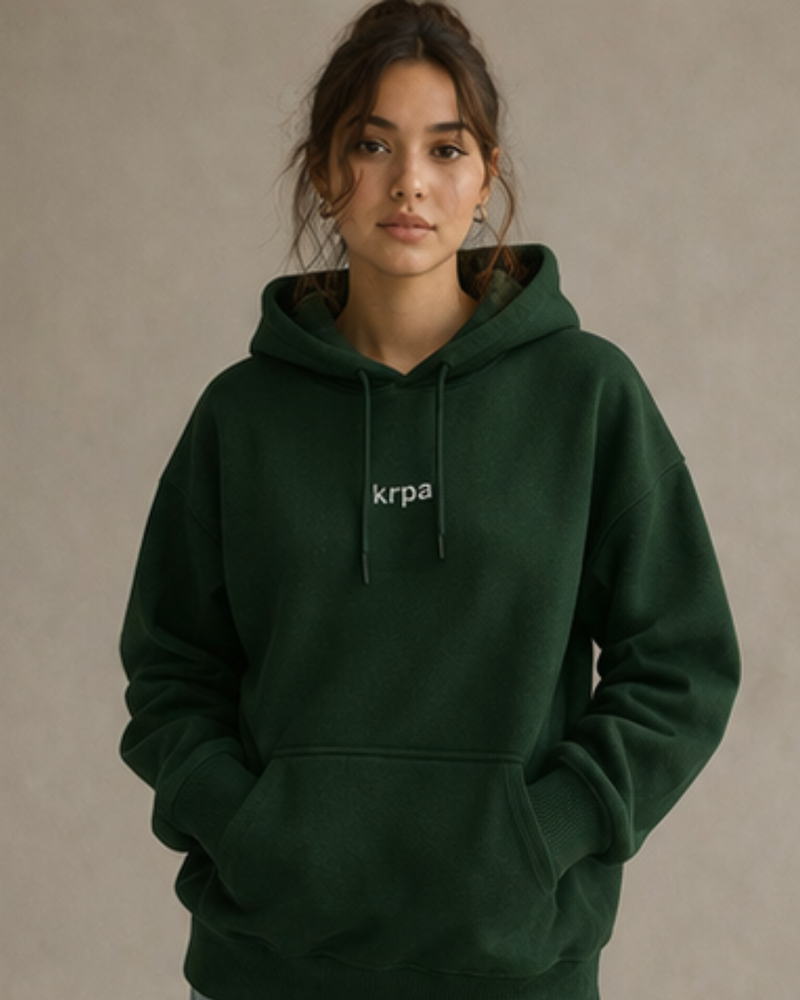 woman wearing KRPA oversized hoodie on a plain background