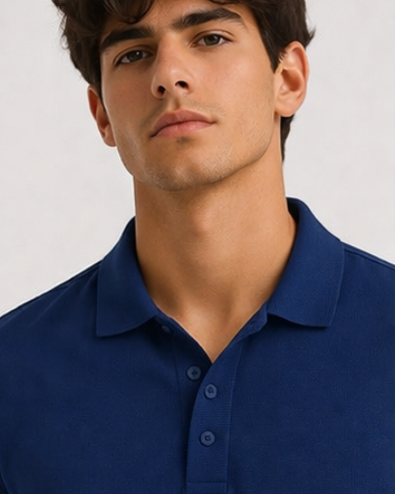 man wearing royal blue polo from KRPA on a plain background 
