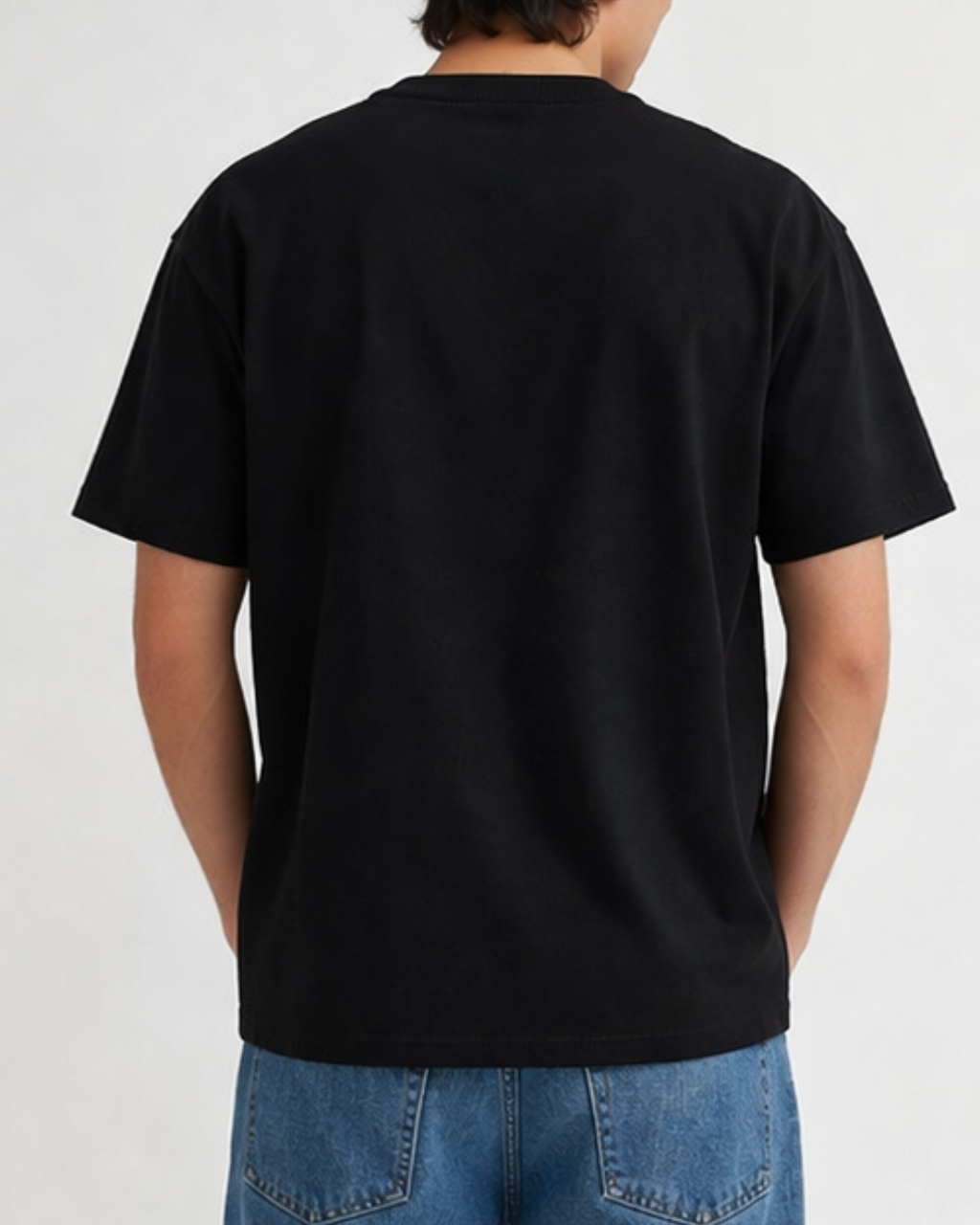 Person wearing a black t-shirt on a plain background