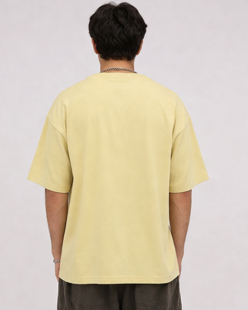 Person wearing a light yellow t-shirt on a plain background