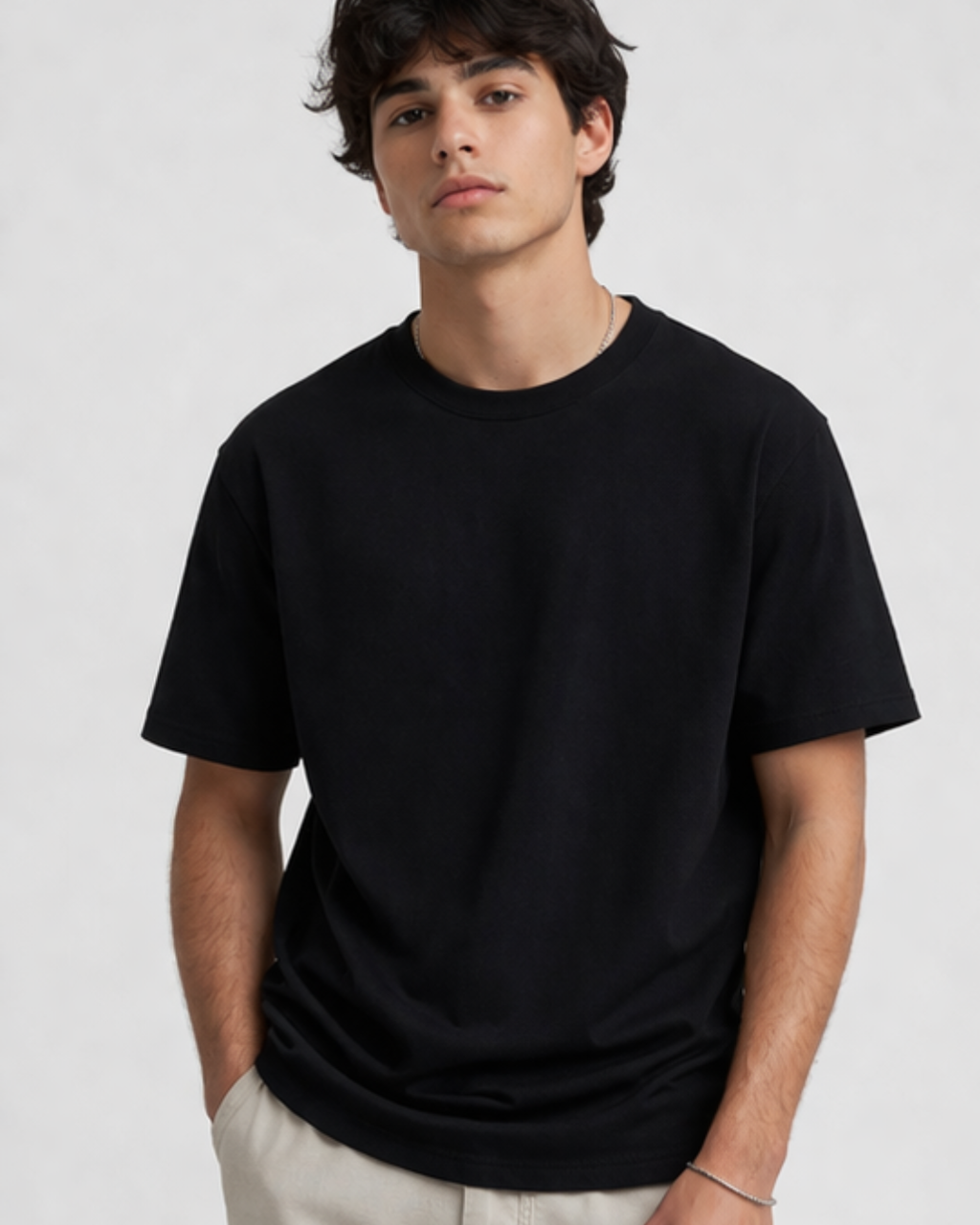Person wearing a black t-shirt against a plain background