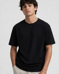 Person wearing a black t-shirt against a plain background