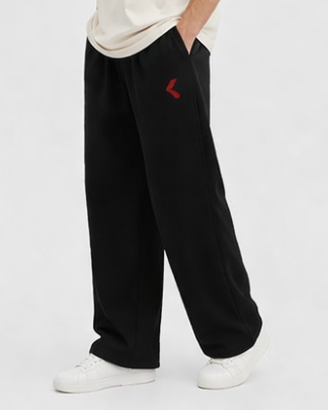 Person wearing black pants with a red KRPA logo on a white background