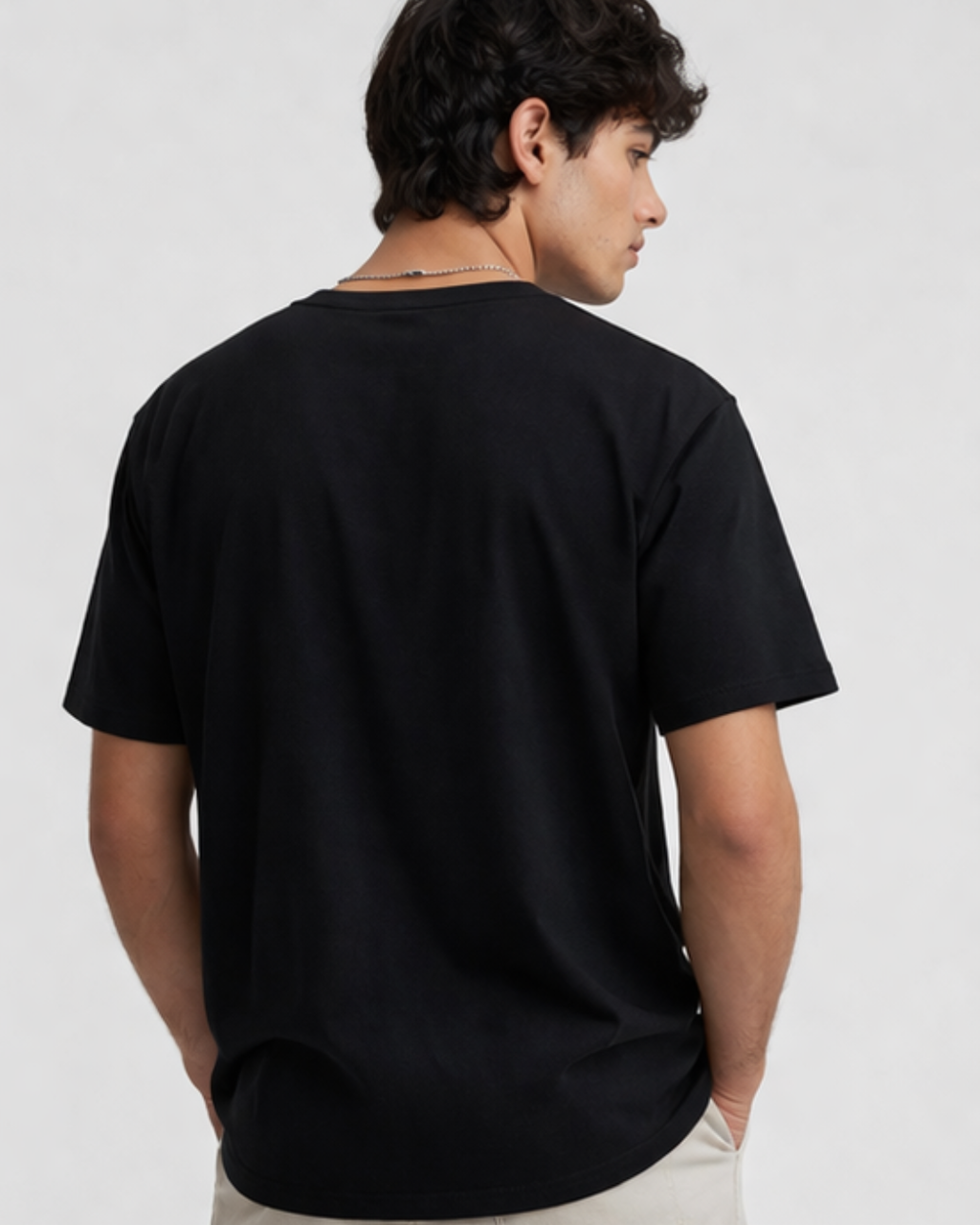 Person wearing a black t-shirt on a plain background
