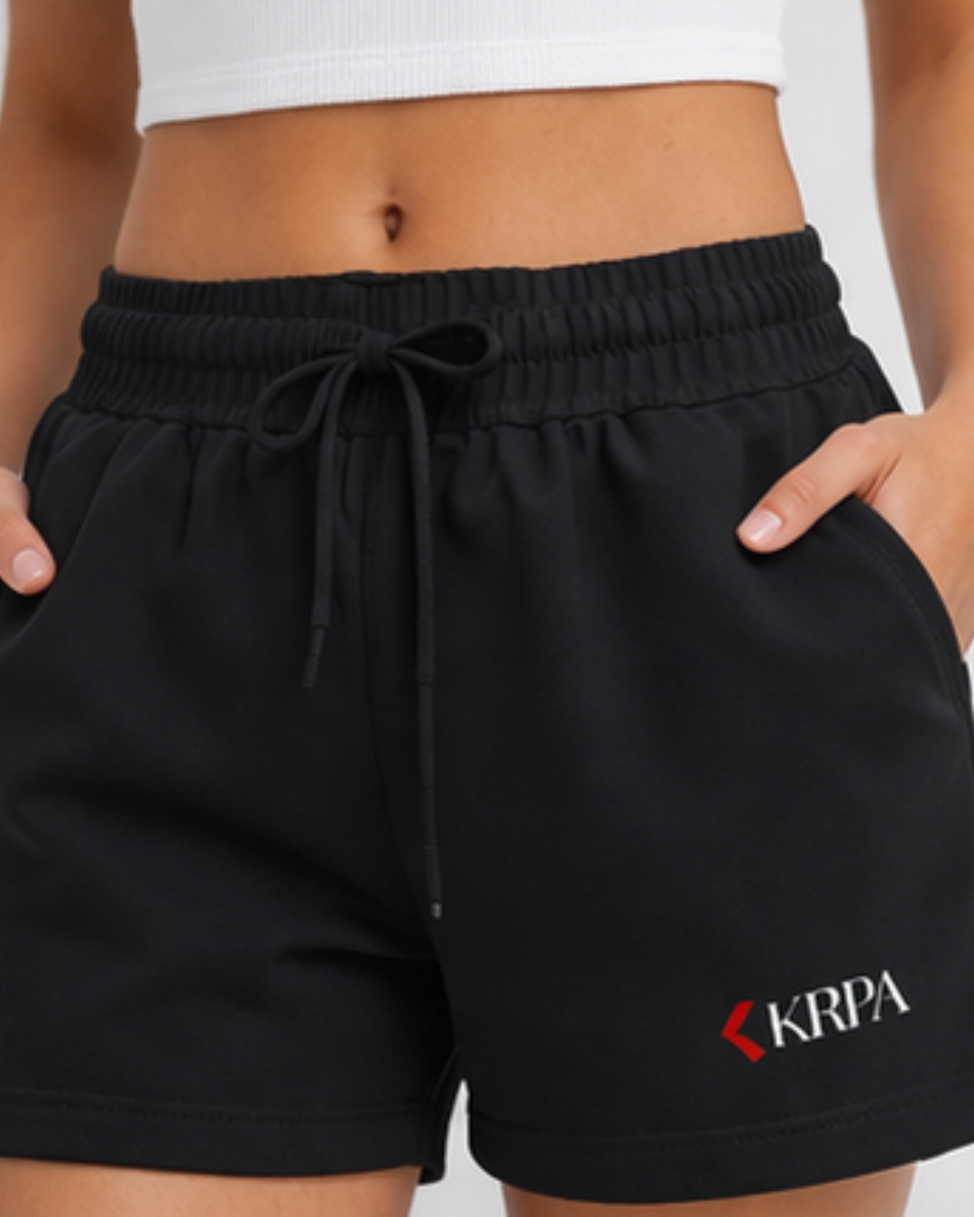 Black shorts with KRPA logo worn by a person on a plain background