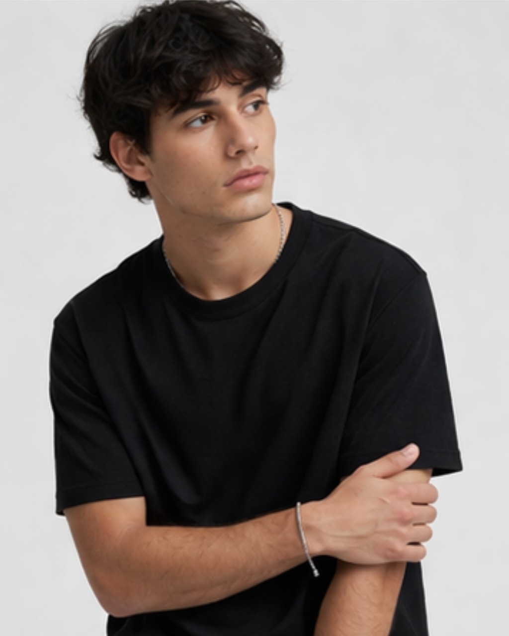 Man wearing a black t-shirt against a plain background