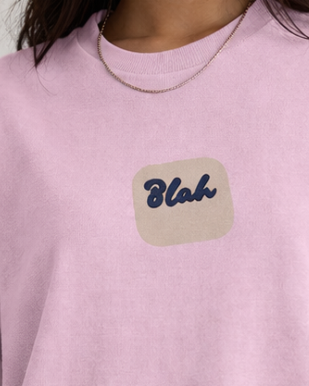 Pink cotton oversized t-shirt with a 'Blah' patch on a neutral background