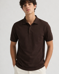 Man wearing a coffee brown polo shirt against a plain background
