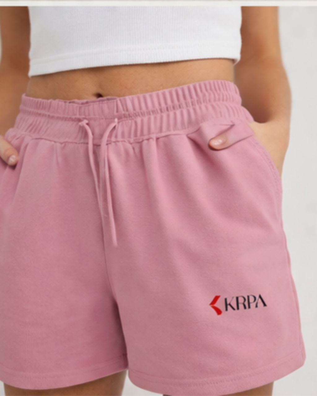 Pink shorts with KRPA logo on a white background