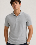 Man wearing a gray polo shirt against a plain background
