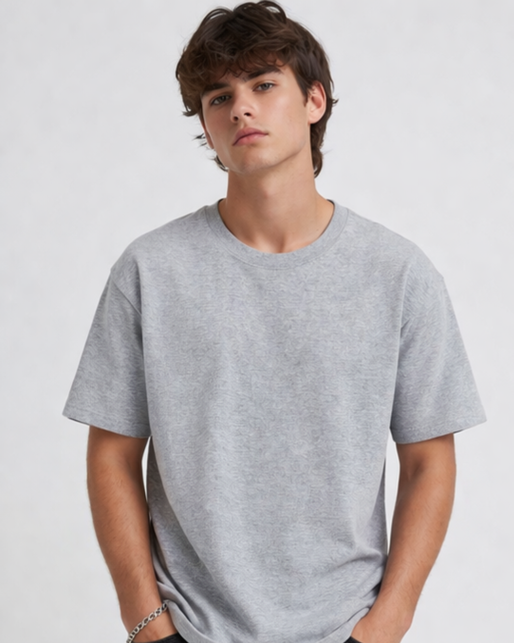 Person wearing a gray t-shirt against a plain background