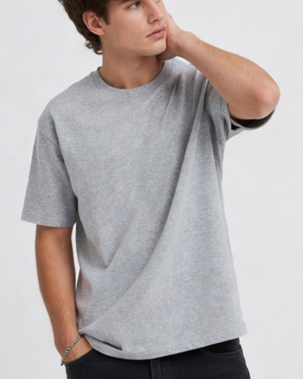 Man wearing a gray t-shirt against a plain background