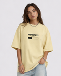 Woman wearing a yellow oversized t-shirt with 'Happiness' text on a plain background