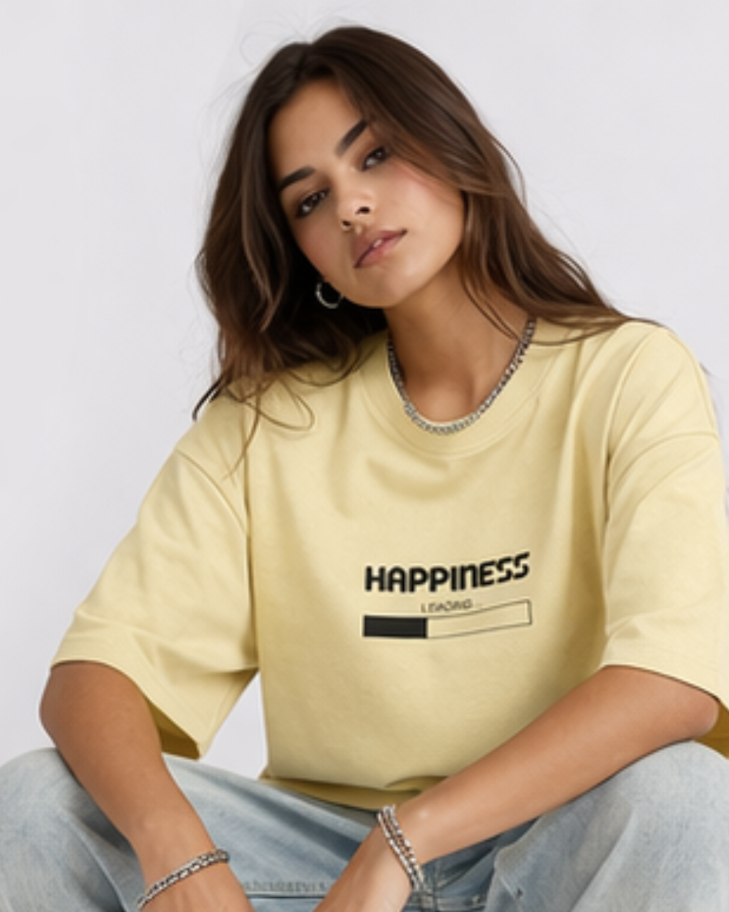 Woman wearing a yellow t-shirt with 'Happiness' text on a plain background