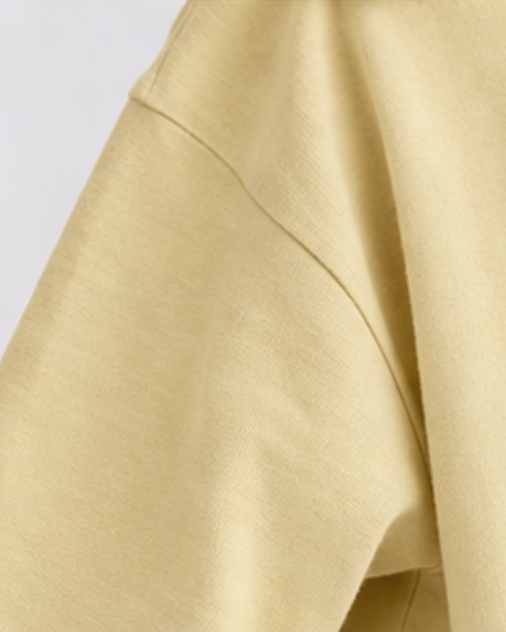 Close-up of a beige fabric texture on a light gray background