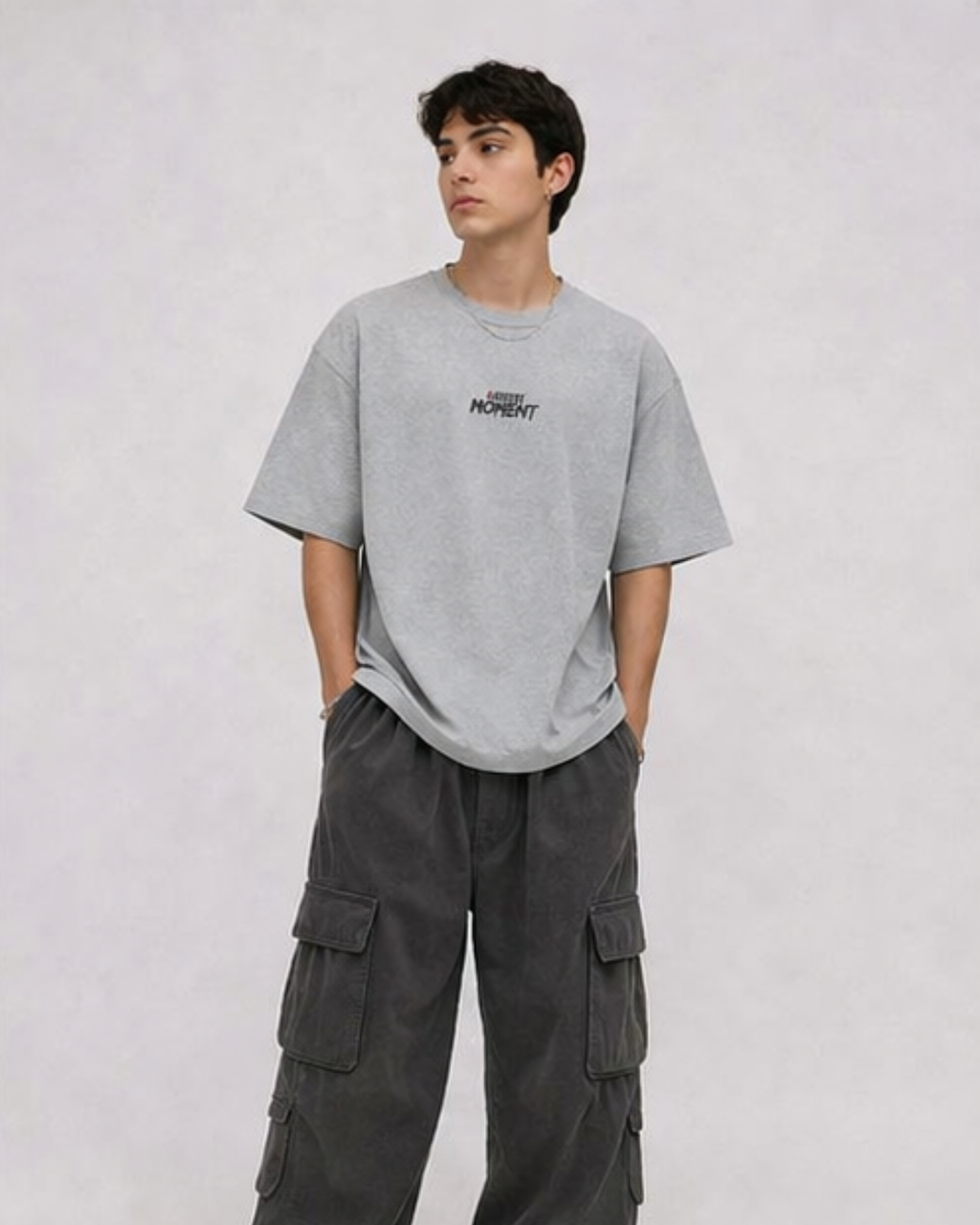 Person wearing a gray t-shirt and cargo pants on a plain background