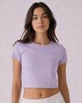 Woman wearing a light purple crop top against a plain background