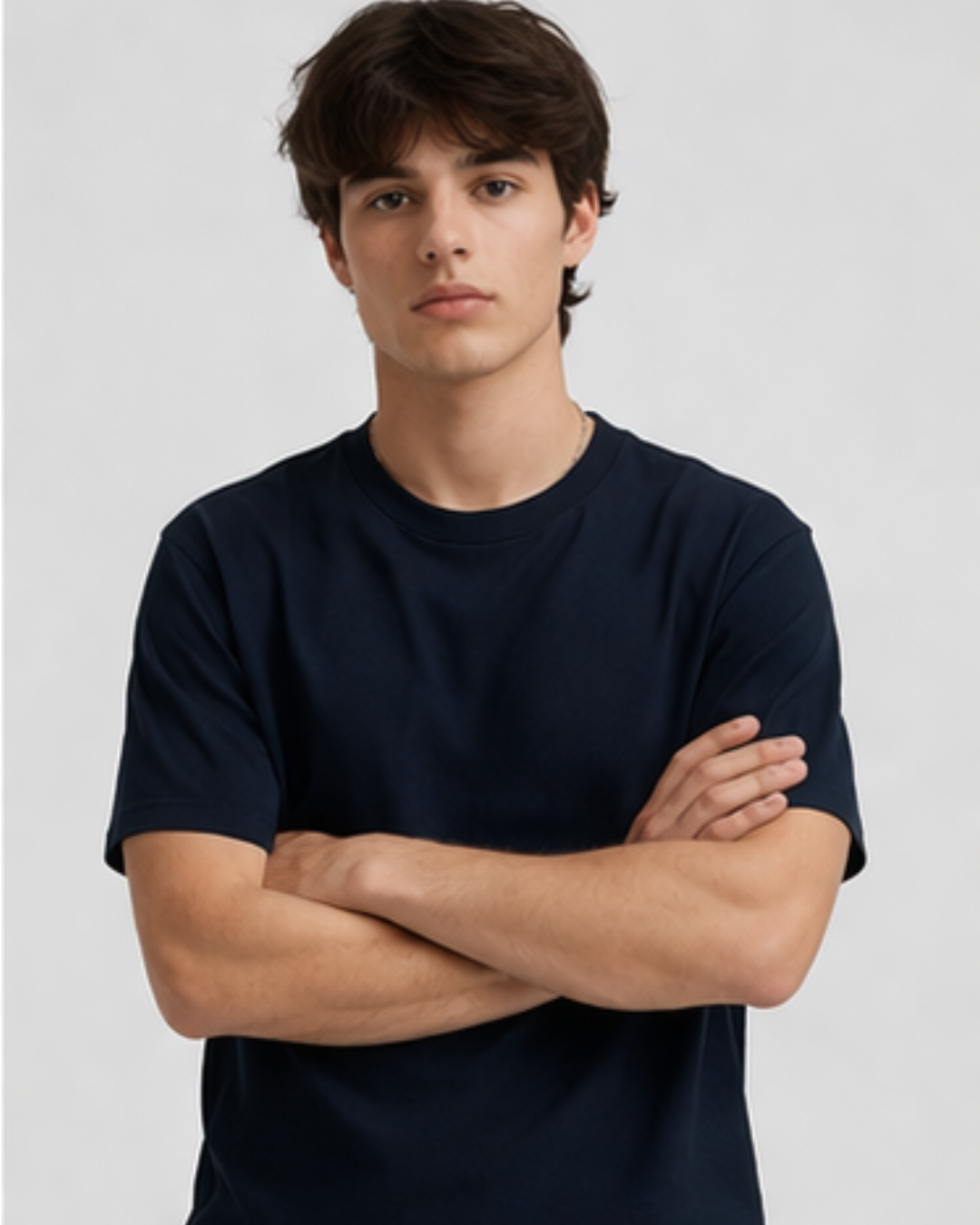 Man wearing a navy blue t-shirt against a plain background