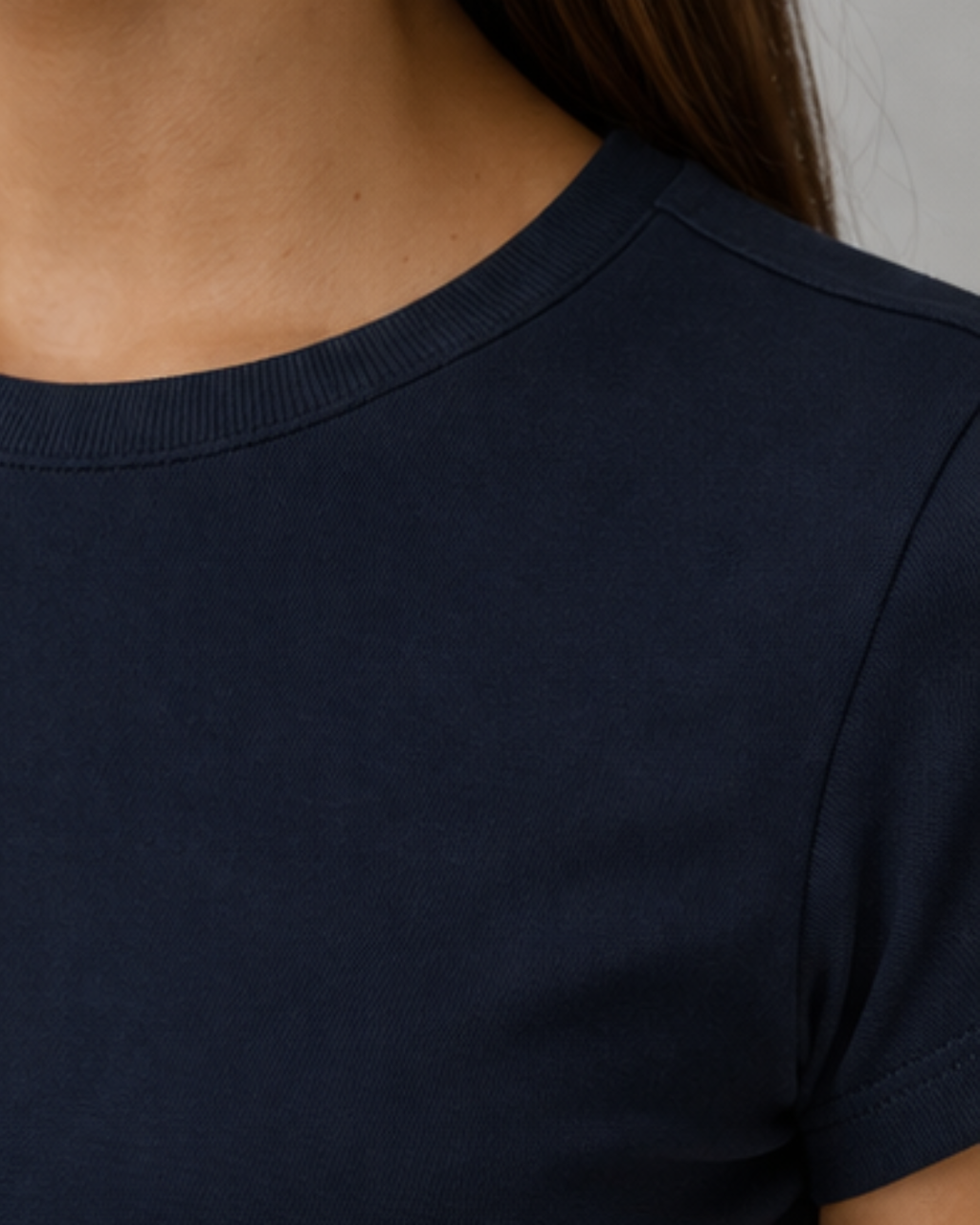 Navy blue t-shirt worn by a person, close-up on the neckline.