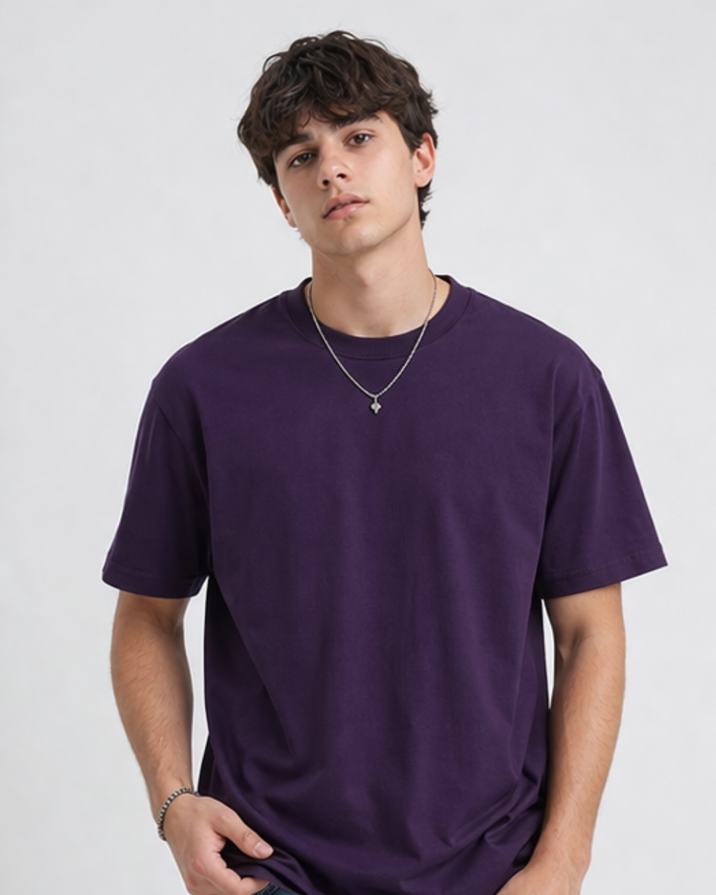 Person wearing a purple t-shirt on a plain background