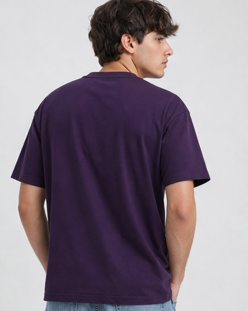 Person wearing a purple t-shirt on a plain background