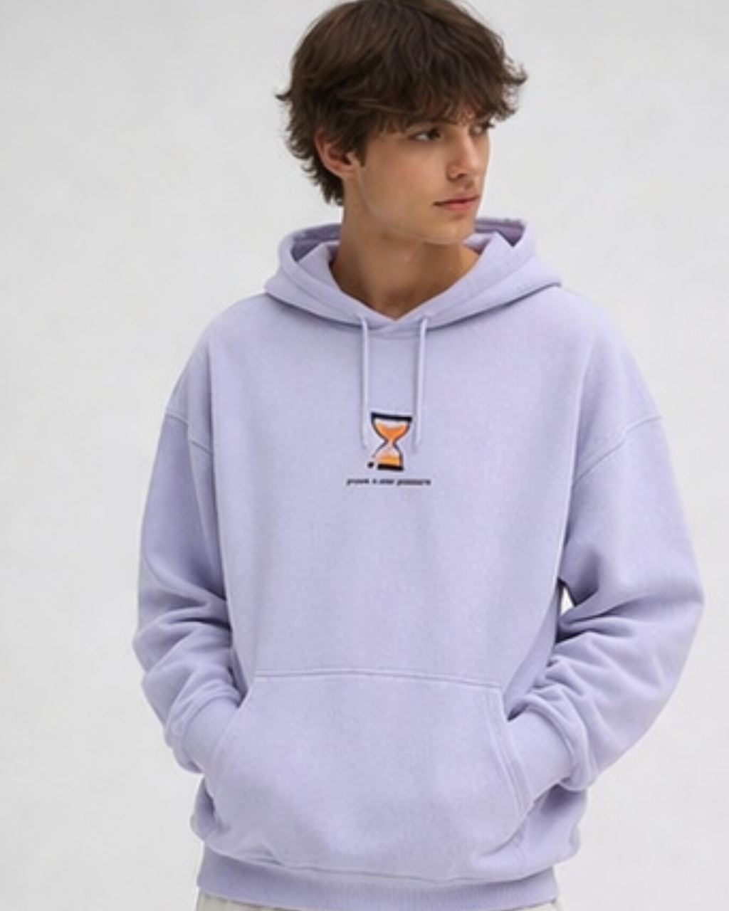 Person wearing a light purple hoodie with a small logo on a plain background