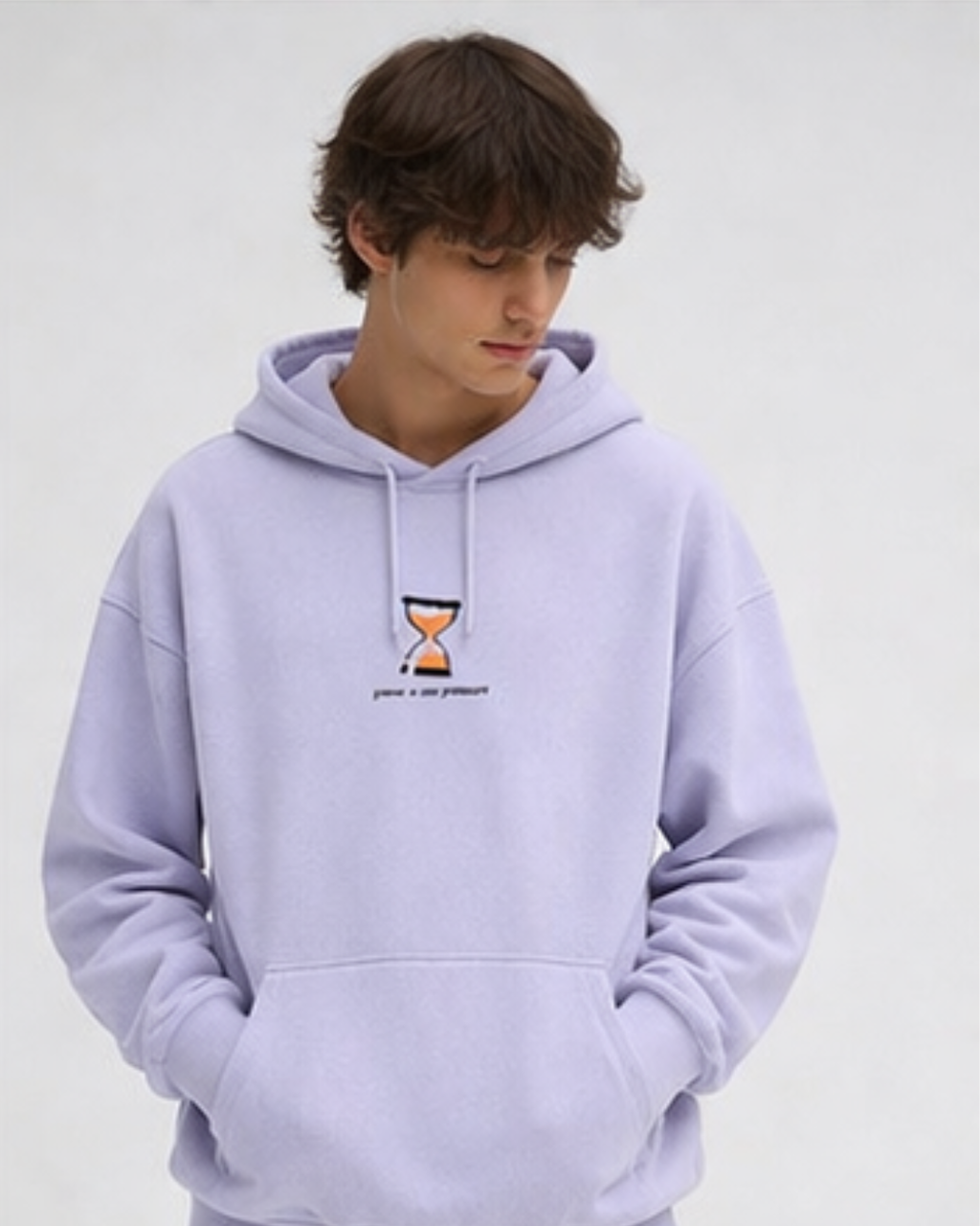 Person wearing a light purple hoodie with a small graphic on a plain background