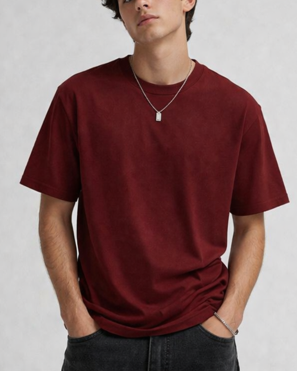 Person wearing a red t-shirt against a plain background