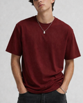 Person wearing a red t-shirt against a plain background