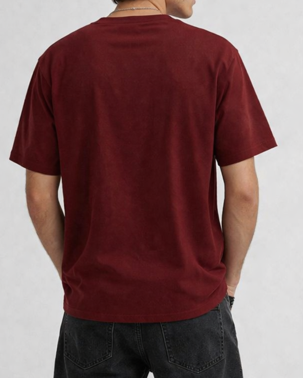 Person wearing a red t-shirt on a plain background