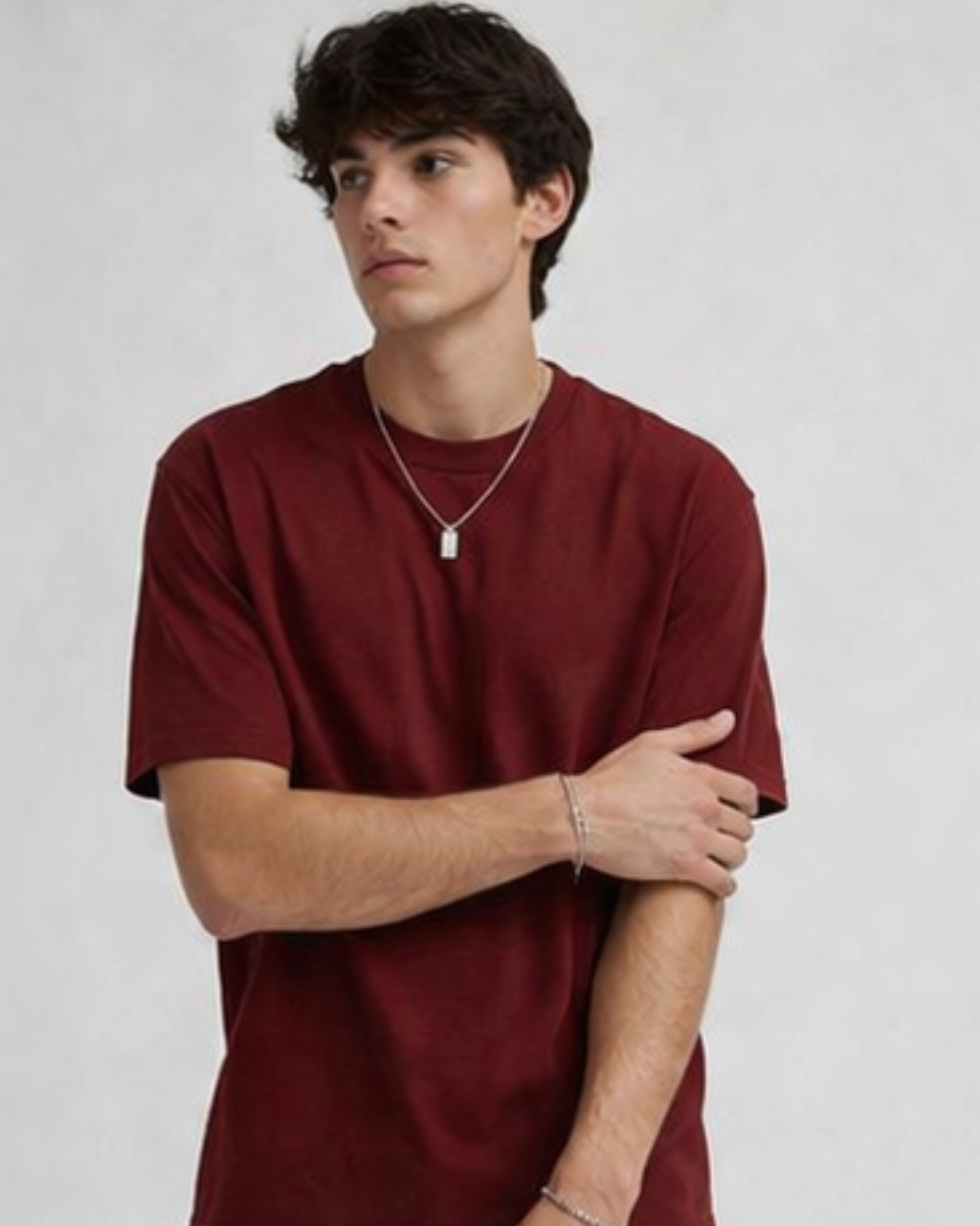 Person wearing a red t-shirt on a plain background