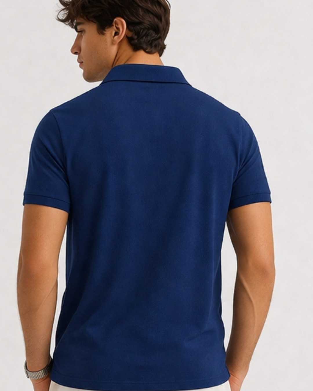 Man wearing a blue polo shirt on a white background