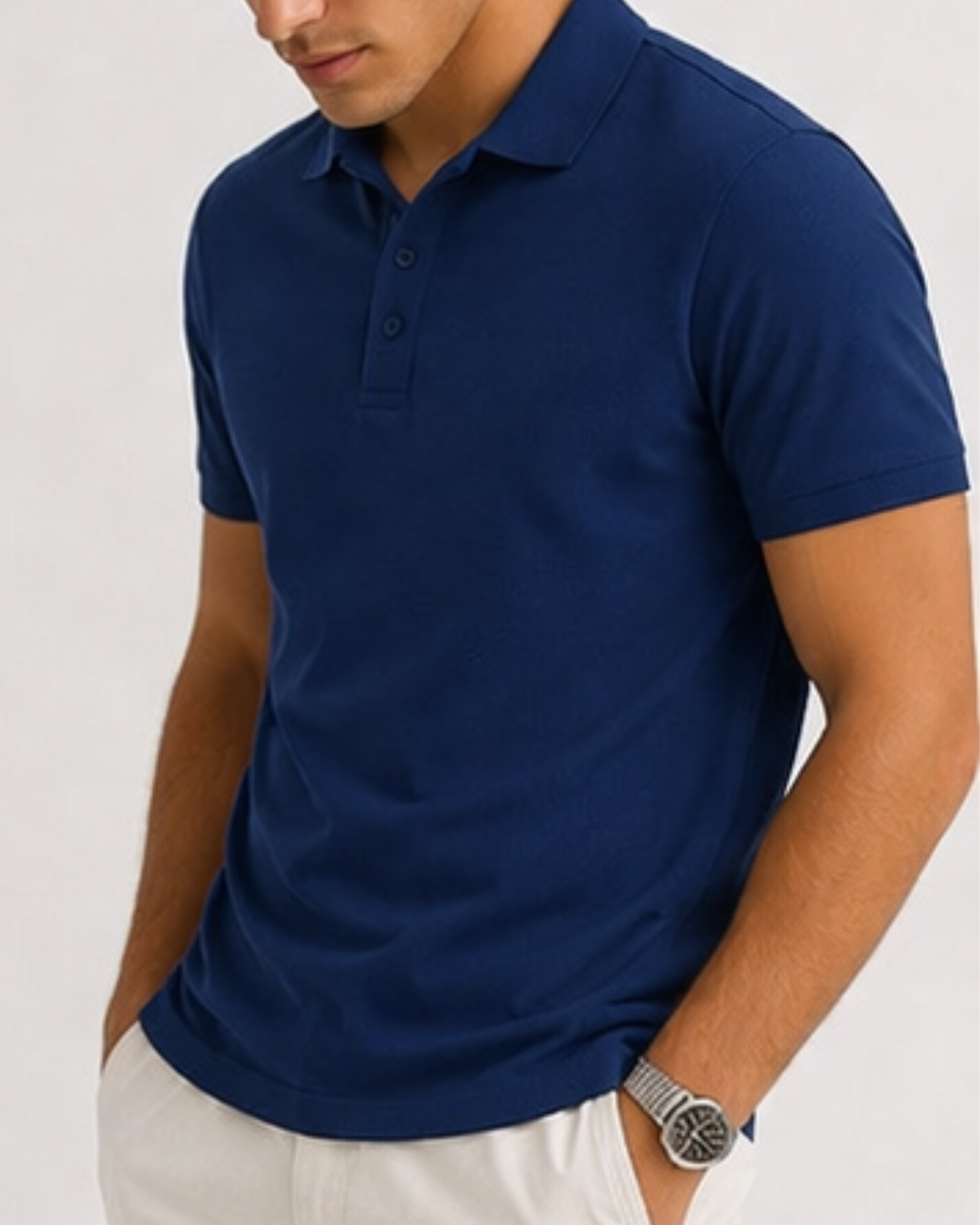Man wearing a blue polo shirt on a light gray background
