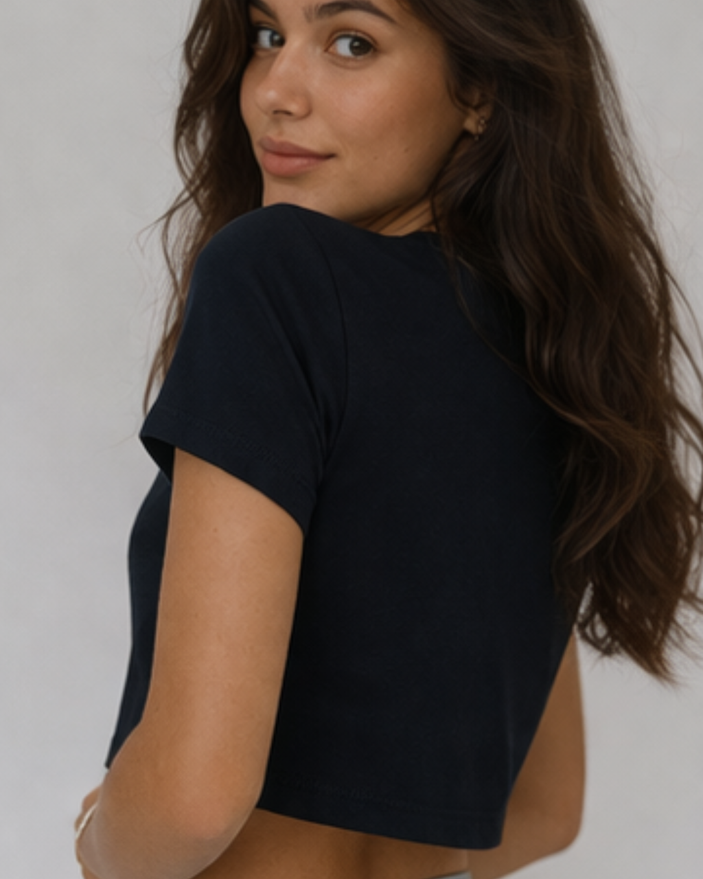 Woman wearing a black t-shirt against a plain background