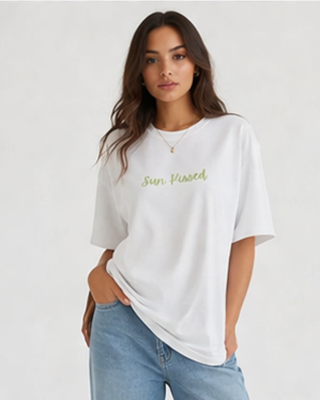 Woman wearing a white t-shirt with 'Sun Kissed' text on a plain background