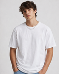 Person wearing a plain white t-shirt against a light gray background