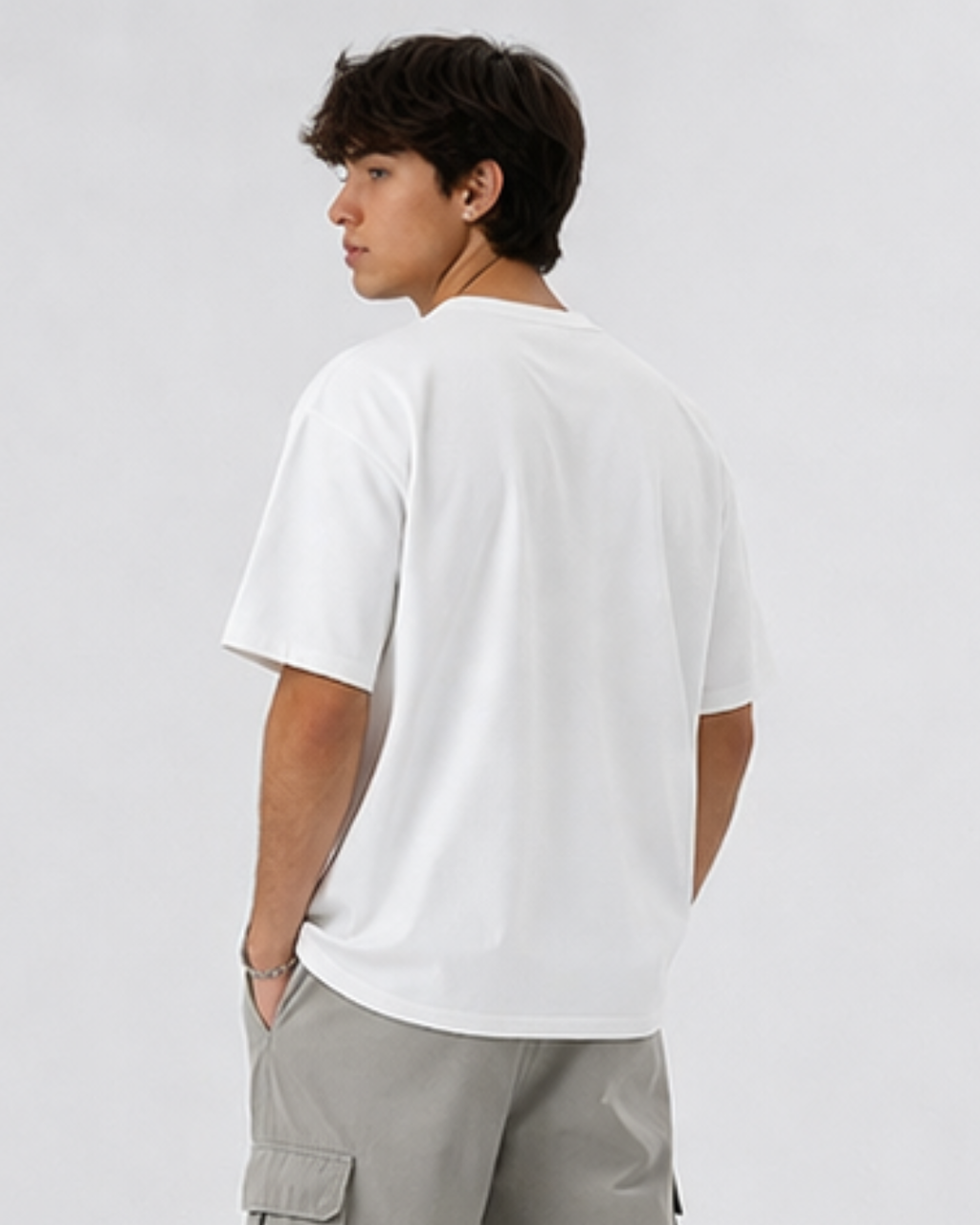 Person wearing a white t-shirt and light gray pants on a plain background