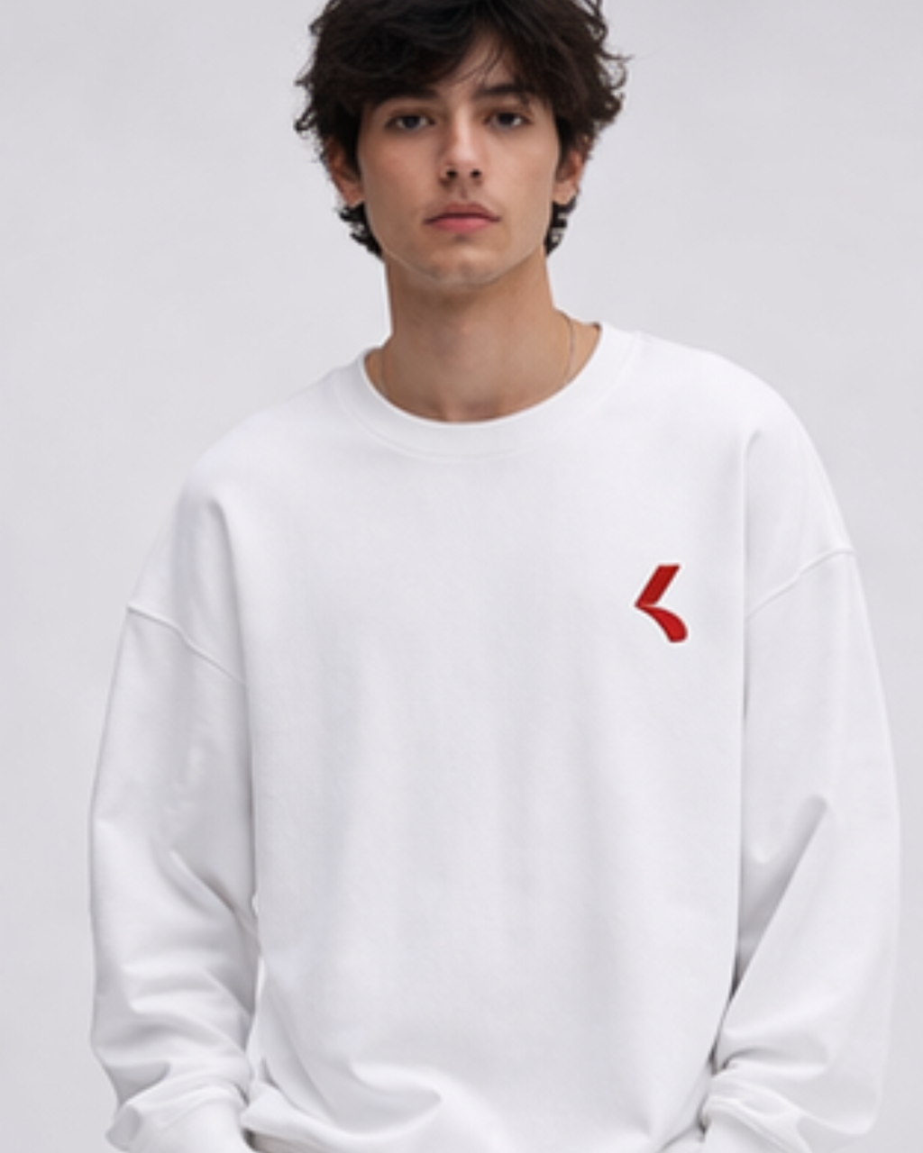Person wearing a white sweatshirt with a red logo on a gray background